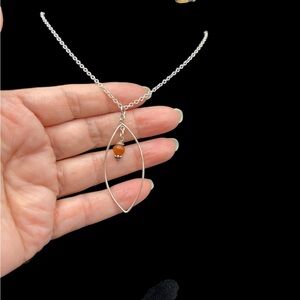 Elegant Silver Pendant Necklace with Brown Accent